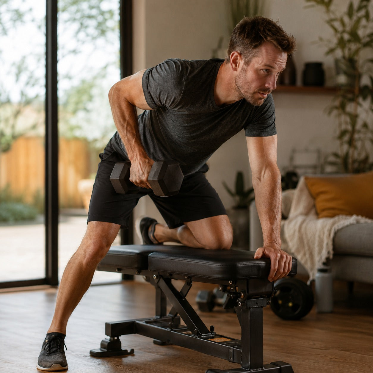 Man exercising with dumbbells in a home setting